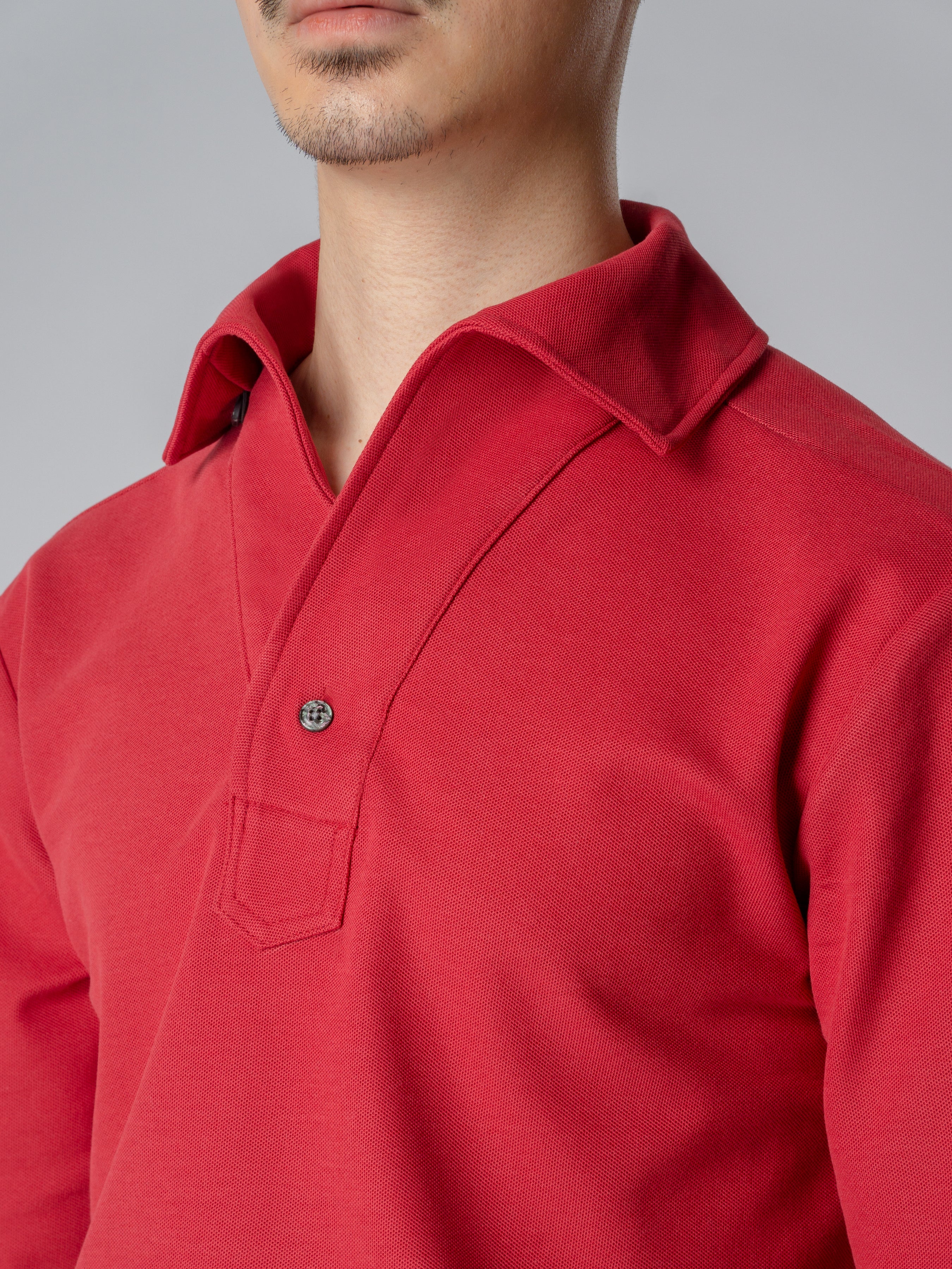 Red long sleeve polo shirt with one-piece collar and single button.