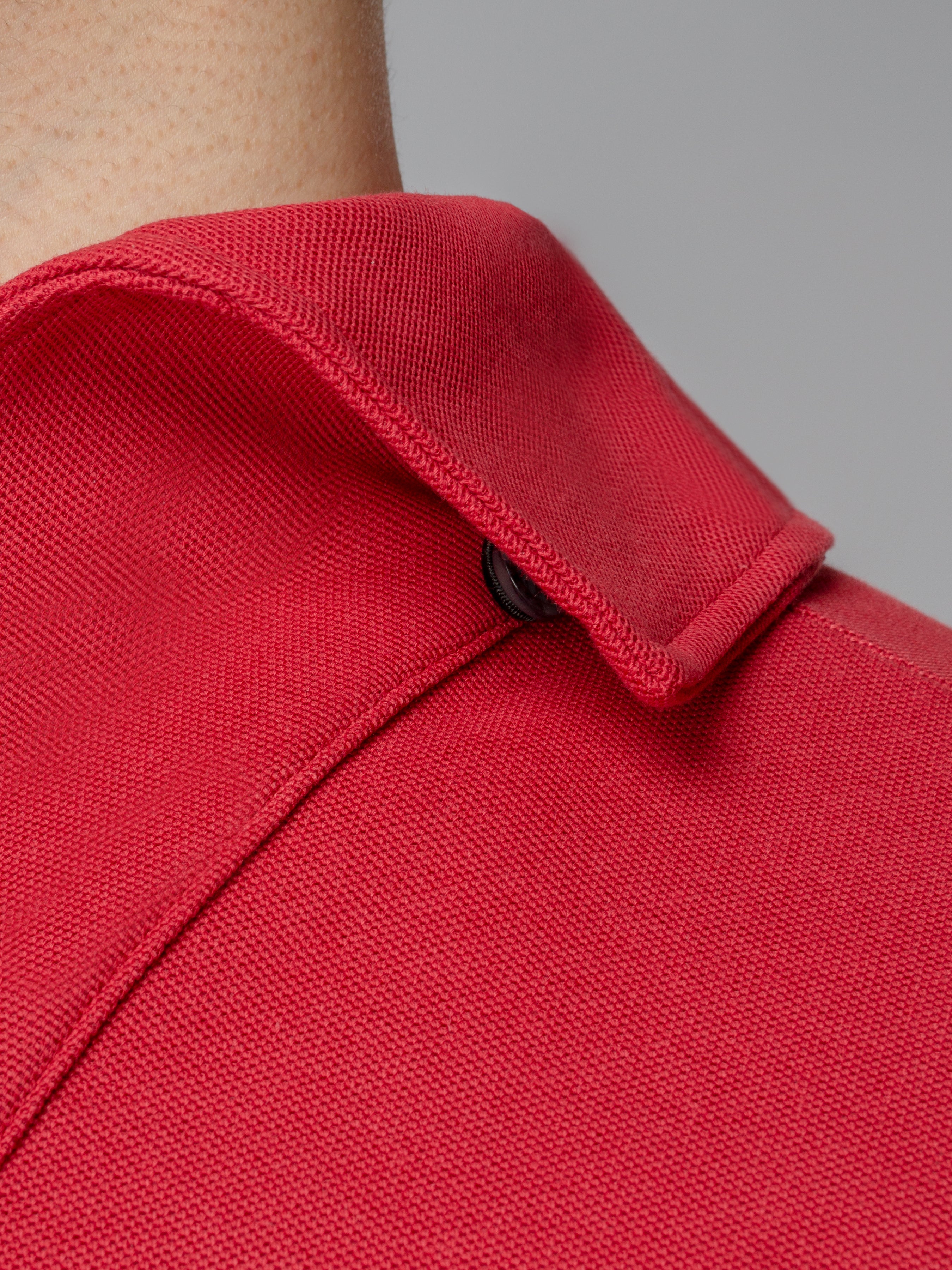 Red long sleeve polo shirt with one-piece collar and single button.