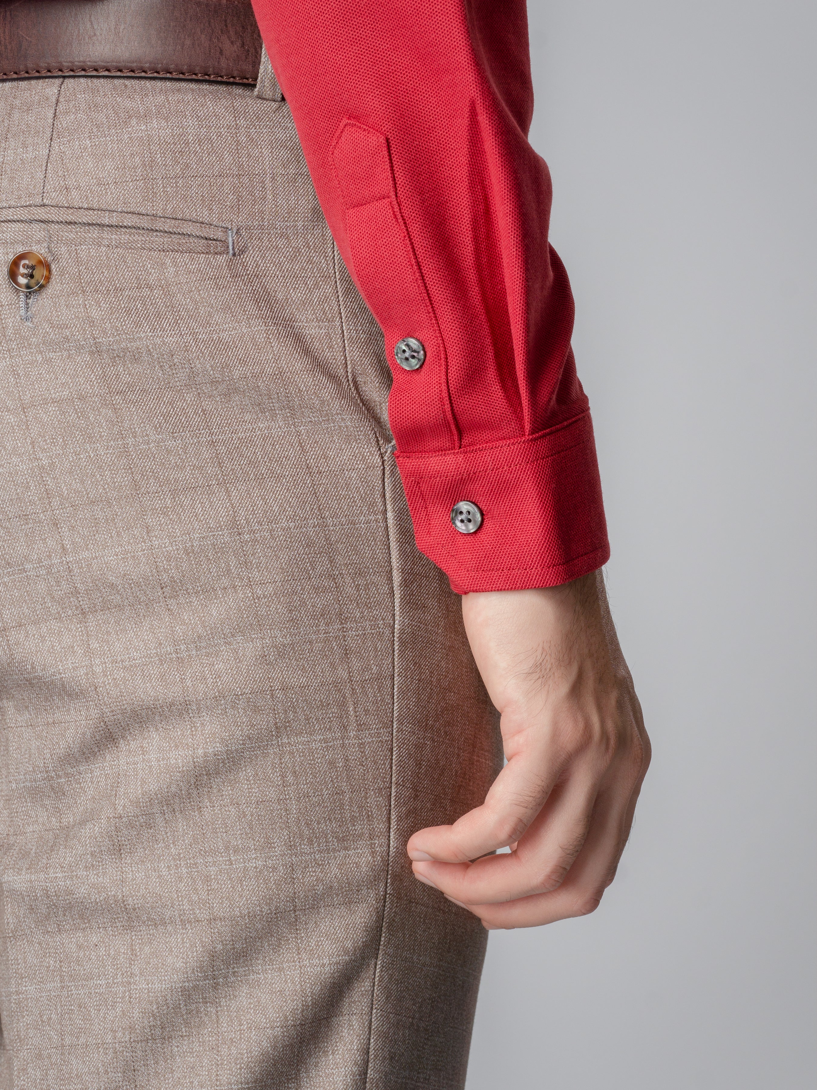 Red long sleeve polo shirt with one-piece collar and single button.